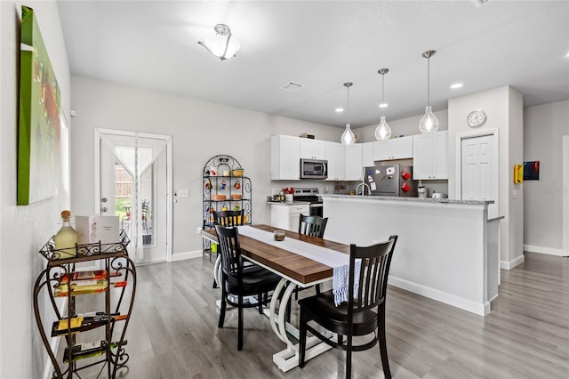 14214 NW 154th Pl, Alachua, FL 32615 - dining area featuring baseboards, light wood-style floors, and recessed lighting