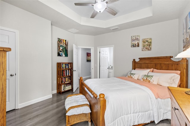 14214 NW 154th Pl, Alachua, FL 32615 - bedroom featuring wood finished floors, a tray ceiling, baseboards, and ceiling fan