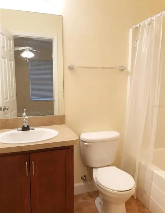 2915 SW 35th Pl Unit 102, Gainesville, FL 32608 - bathroom featuring vanity, toilet, shower / bathtub combination with curtain, a ceiling fan, and tile patterned flooring