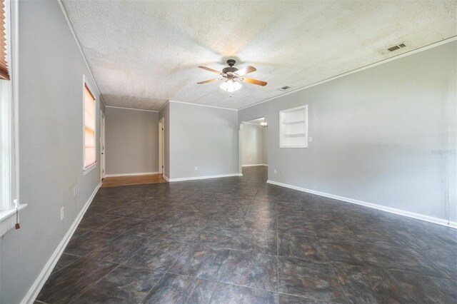 1404 NW 10th Ave, Gainesville, FL 32605 - unfurnished room with a ceiling fan, a textured ceiling, and crown molding