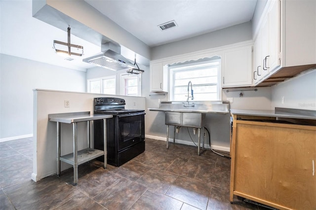 1404 NW 10th Ave, Gainesville, FL 32605 - kitchen featuring black range with electric cooktop, island exhaust hood, white cabinetry, and light countertops