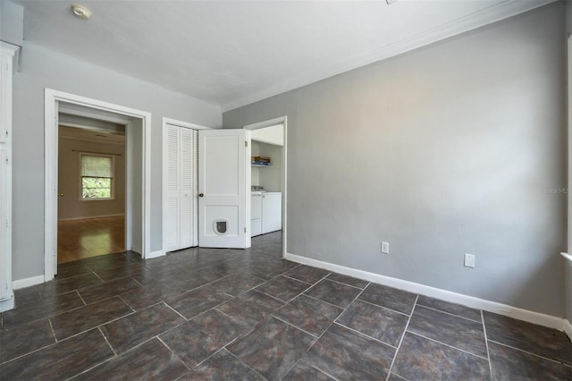 1404 NW 10th Ave, Gainesville, FL 32605 - unfurnished bedroom featuring washer and dryer, a closet, and crown molding