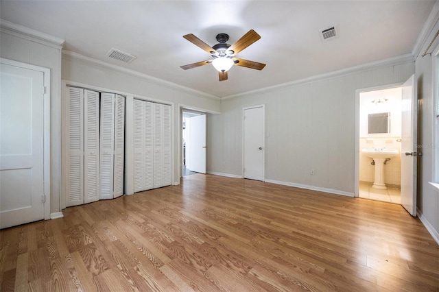 1404 NW 10th Ave, Gainesville, FL 32605 - unfurnished bedroom featuring light wood-style floors, ornamental molding, ensuite bath, and a ceiling fan