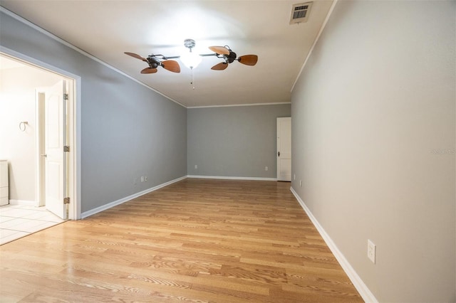 1404 NW 10th Ave, Gainesville, FL 32605 - spare room featuring crown molding, ceiling fan, and light wood-type flooring
