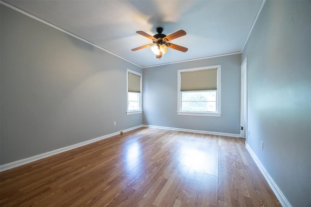 1404 NW 10th Ave, Gainesville, FL 32605 - spare room featuring crown molding, a ceiling fan, and wood finished floors