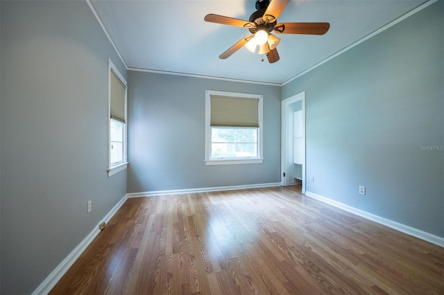 1404 NW 10th Ave, Gainesville, FL 32605 - spare room featuring plenty of natural light, wood finished floors, ornamental molding, and ceiling fan