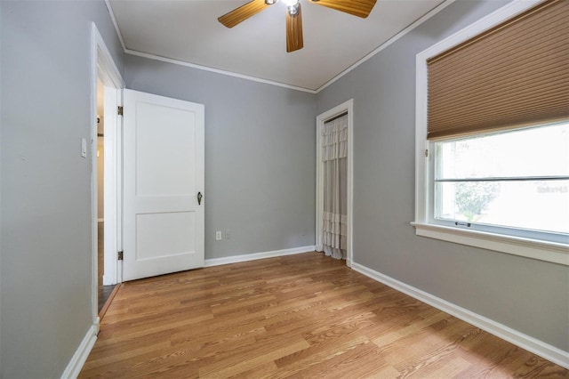 1404 NW 10th Ave, Gainesville, FL 32605 - unfurnished bedroom with crown molding, light wood finished floors, a closet, and ceiling fan