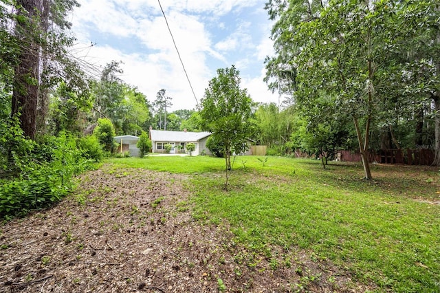 1404 NW 10th Ave, Gainesville, FL 32605 - view of green lawn with a detached carport