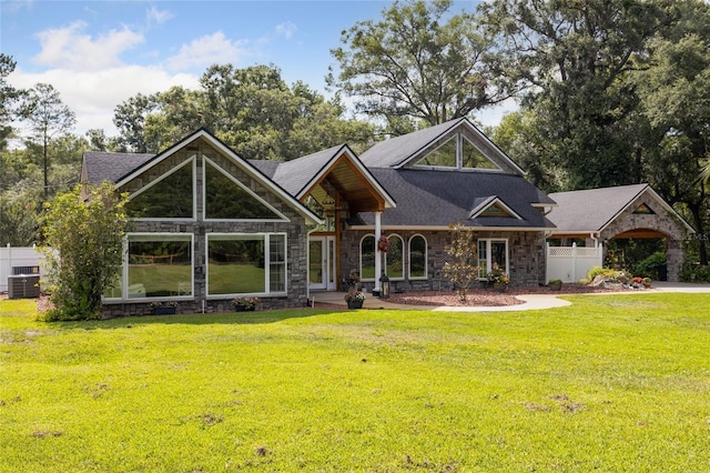 518 SW Little Rd, Lake City, FL 32024 - view of front facade featuring stone siding, cooling unit, and a shingled roof