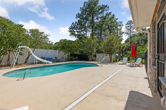 518 SW Little Rd, Lake City, FL 32024 - view of swimming pool with a water slide, a patio, and a fenced backyard