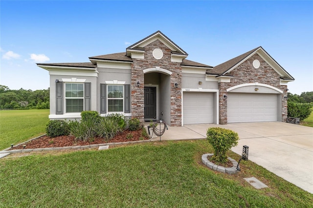 5604 SW 215th Ter, Newberry, FL 32669 - view of front of home featuring stucco siding, a garage, concrete driveway, stone siding, and a front lawn