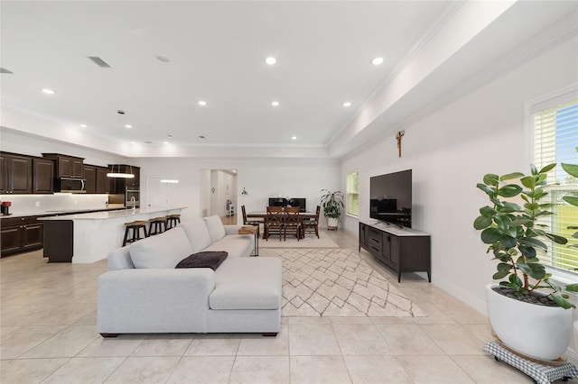 5604 SW 215th Ter, Newberry, FL 32669 - living area featuring light tile patterned floors, ornamental molding, a raised ceiling, and recessed lighting
