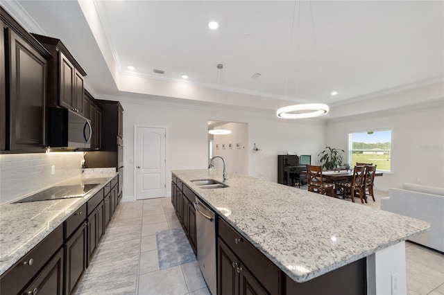 5604 SW 215th Ter, Newberry, FL 32669 - kitchen featuring black electric stovetop, stainless steel dishwasher, a tray ceiling, a large island with sink, and tasteful backsplash