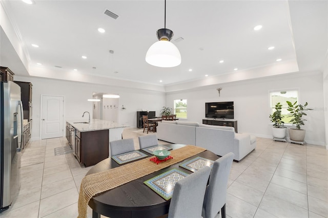 5604 SW 215th Ter, Newberry, FL 32669 - dining room featuring light tile patterned floors, a tray ceiling, and ornamental molding