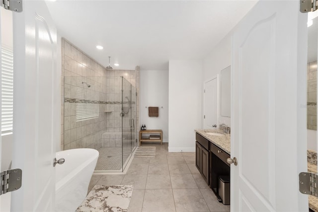 5604 SW 215th Ter, Newberry, FL 32669 - bathroom featuring a stall shower, vanity, a freestanding tub, tile patterned flooring, and recessed lighting