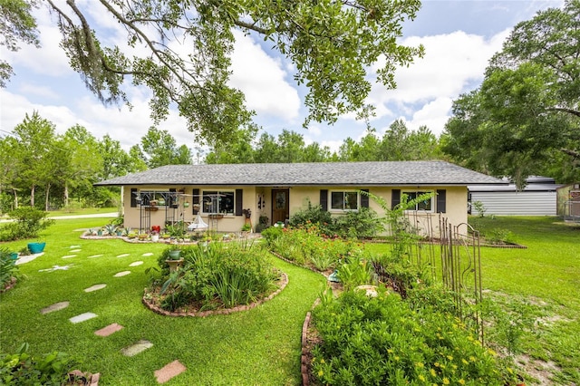 261 Ishie Ave, Bronson, FL 32621 - ranch-style house with stucco siding and a front yard