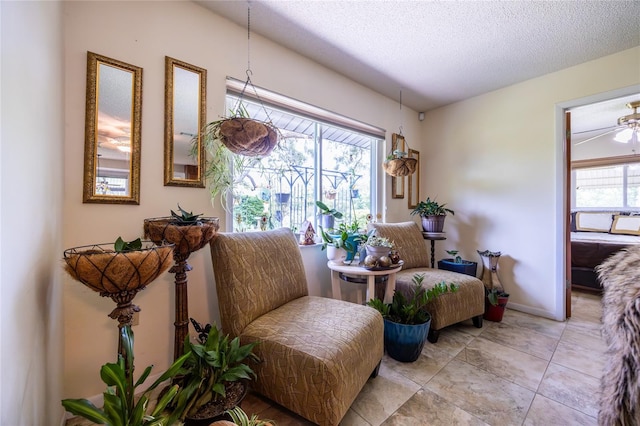 261 Ishie Ave, Bronson, FL 32621 - sitting room with a textured ceiling and light tile patterned flooring