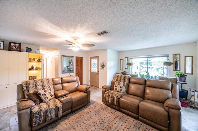 261 Ishie Ave, Bronson, FL 32621 - living room with ceiling fan and a textured ceiling