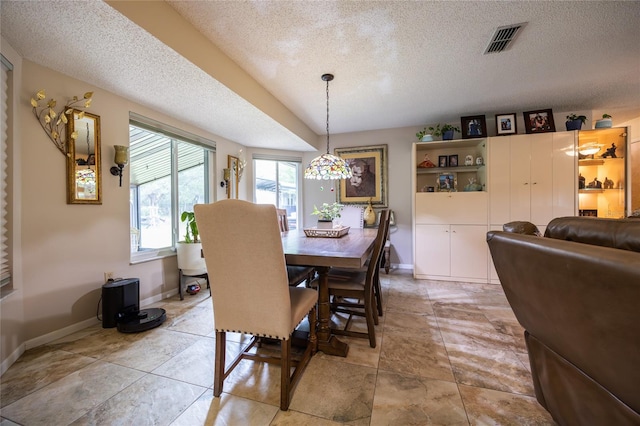 261 Ishie Ave, Bronson, FL 32621 - dining room featuring a textured ceiling and baseboards
