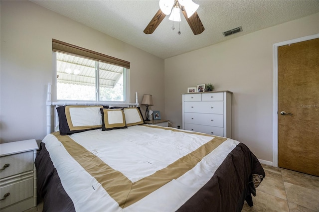 261 Ishie Ave, Bronson, FL 32621 - bedroom with a textured ceiling and a ceiling fan