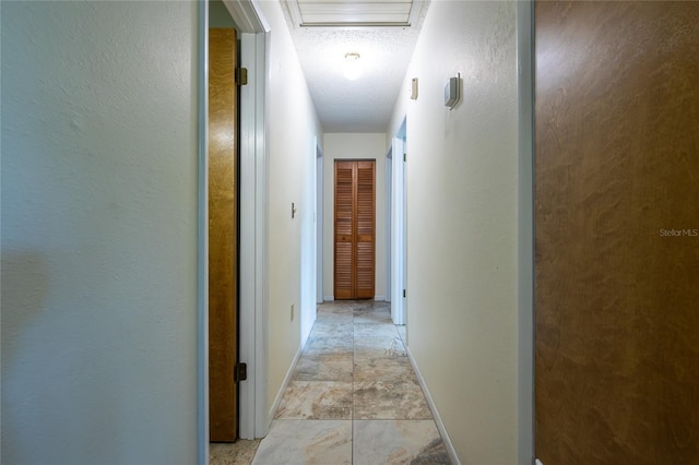 261 Ishie Ave, Bronson, FL 32621 - corridor featuring attic access and a textured ceiling