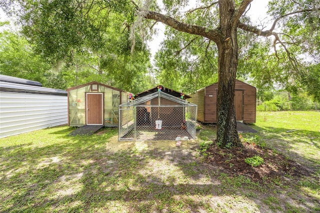 261 Ishie Ave, Bronson, FL 32621 - view of green lawn featuring a storage shed and exterior structure