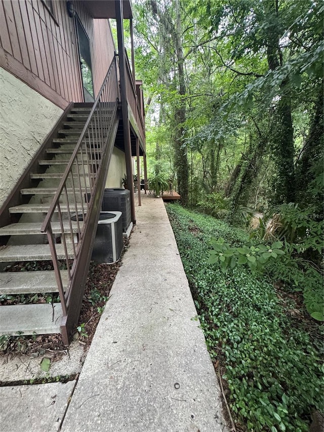1515 NW 29th Rd Unit E3, Gainesville, FL 32605 - view of property exterior featuring stairs and central AC