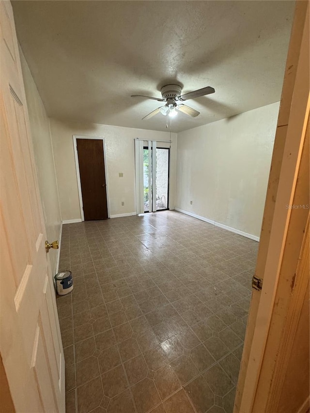 1515 NW 29th Rd Unit E3, Gainesville, FL 32605 - unfurnished room featuring a ceiling fan, baseboards, and a textured ceiling