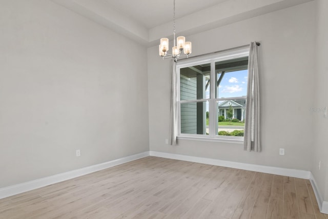 3520 SW 120th Dr, Gainesville, FL 32608 - spare room featuring a chandelier and light wood-type flooring