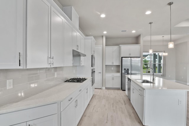 3520 SW 120th Dr, Gainesville, FL 32608 - kitchen with white cabinetry, tasteful backsplash, light wood-style flooring, appliances with stainless steel finishes, and recessed lighting