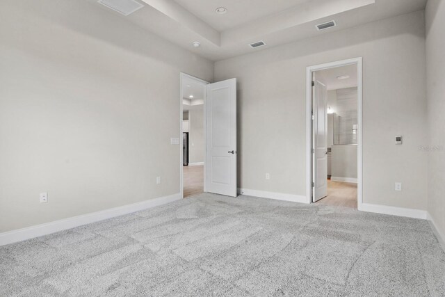 3520 SW 120th Dr, Gainesville, FL 32608 - unfurnished bedroom with light colored carpet, a raised ceiling, and recessed lighting