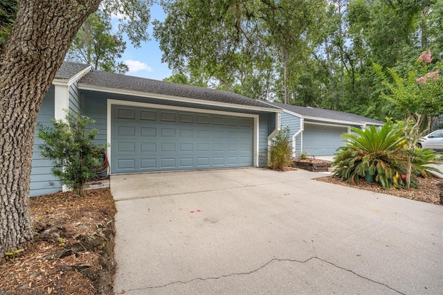 5328 NW 9th Ln, Gainesville, FL 32605 - view of front facade featuring concrete driveway and a shingled roof