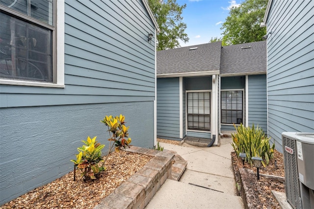 5328 NW 9th Ln, Gainesville, FL 32605 - property entrance featuring central AC unit and a shingled roof