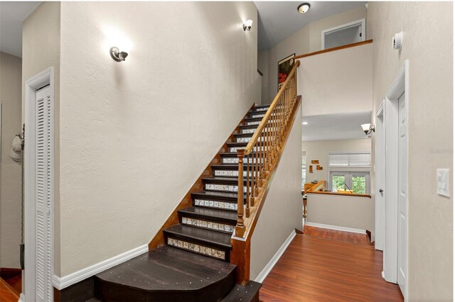 5328 NW 9th Ln, Gainesville, FL 32605 - staircase featuring wood finished floors and baseboards