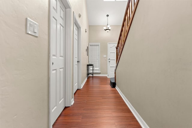 5328 NW 9th Ln, Gainesville, FL 32605 - hall featuring stairway, wood finished floors, baseboards, and a chandelier