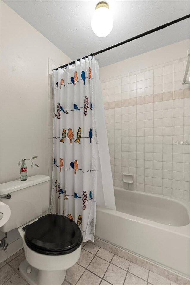 5328 NW 9th Ln, Gainesville, FL 32605 - full bathroom featuring shower / bath combo, toilet, and tile patterned floors