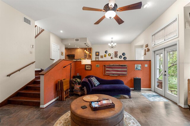 5328 NW 9th Ln, Gainesville, FL 32605 - living room featuring baseboards, stone finish flooring, a chandelier, a ceiling fan, and stairs