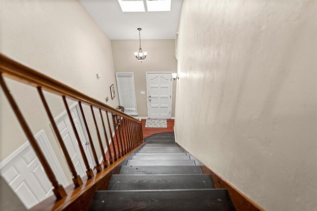 5328 NW 9th Ln, Gainesville, FL 32605 - stairway featuring a skylight, wood finished floors, and a chandelier