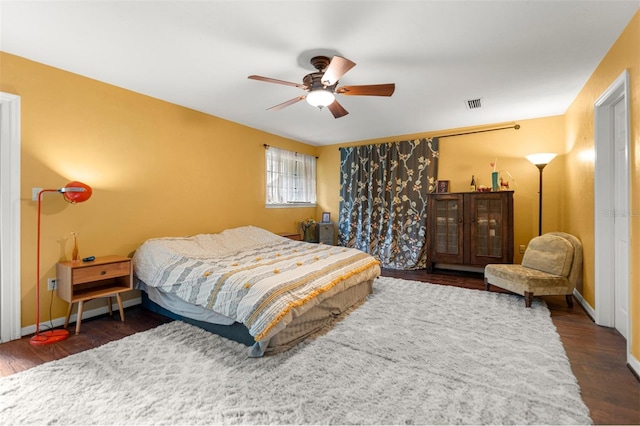 5328 NW 9th Ln, Gainesville, FL 32605 - bedroom featuring dark wood finished floors, a ceiling fan, and baseboards