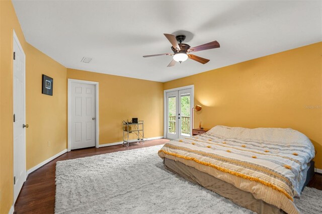 5328 NW 9th Ln, Gainesville, FL 32605 - bedroom with access to exterior, dark wood-style flooring, ceiling fan, and baseboards