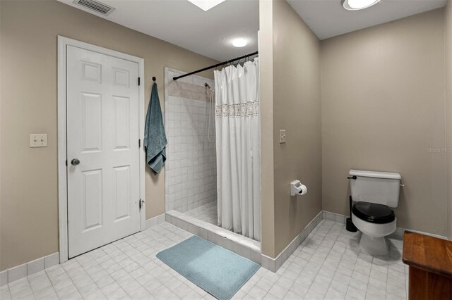 5328 NW 9th Ln, Gainesville, FL 32605 - bathroom with toilet, a shower stall, and baseboards