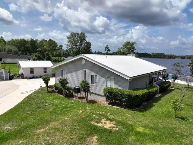 131 Ida Blvd, Interlachen, FL 32148 - view of home's exterior with a yard, a water view, central AC, and metal roof