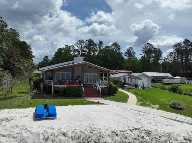 131 Ida Blvd, Interlachen, FL 32148 - view of front of property featuring french doors, a front lawn, and a chimney