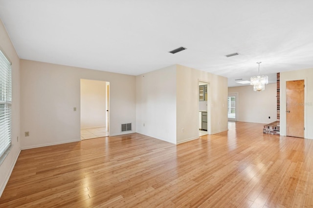 2626 NW 36th Pl, Gainesville, FL 32605 - unfurnished room with a chandelier and light wood finished floors