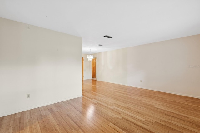 2626 NW 36th Pl, Gainesville, FL 32605 - spare room with light wood finished floors and a chandelier