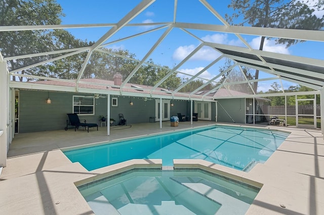 2626 NW 36th Pl, Gainesville, FL 32605 - view of swimming pool featuring a patio area, a pool with connected hot tub, and glass enclosure