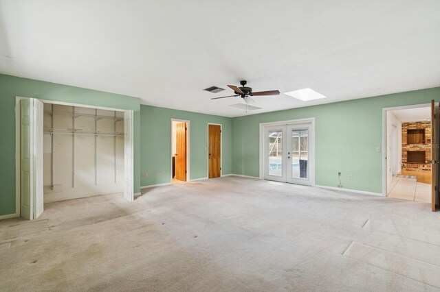2626 NW 36th Pl, Gainesville, FL 32605 - unfurnished bedroom featuring french doors, carpet floors, a skylight, access to exterior, and ceiling fan