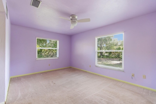 2626 NW 36th Pl, Gainesville, FL 32605 - carpeted empty room with plenty of natural light and ceiling fan
