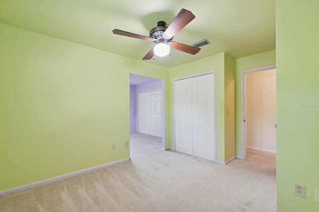 2626 NW 36th Pl, Gainesville, FL 32605 - unfurnished bedroom with carpet floors, multiple closets, and a ceiling fan