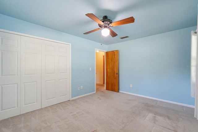2626 NW 36th Pl, Gainesville, FL 32605 - unfurnished bedroom featuring carpet, a closet, and a ceiling fan